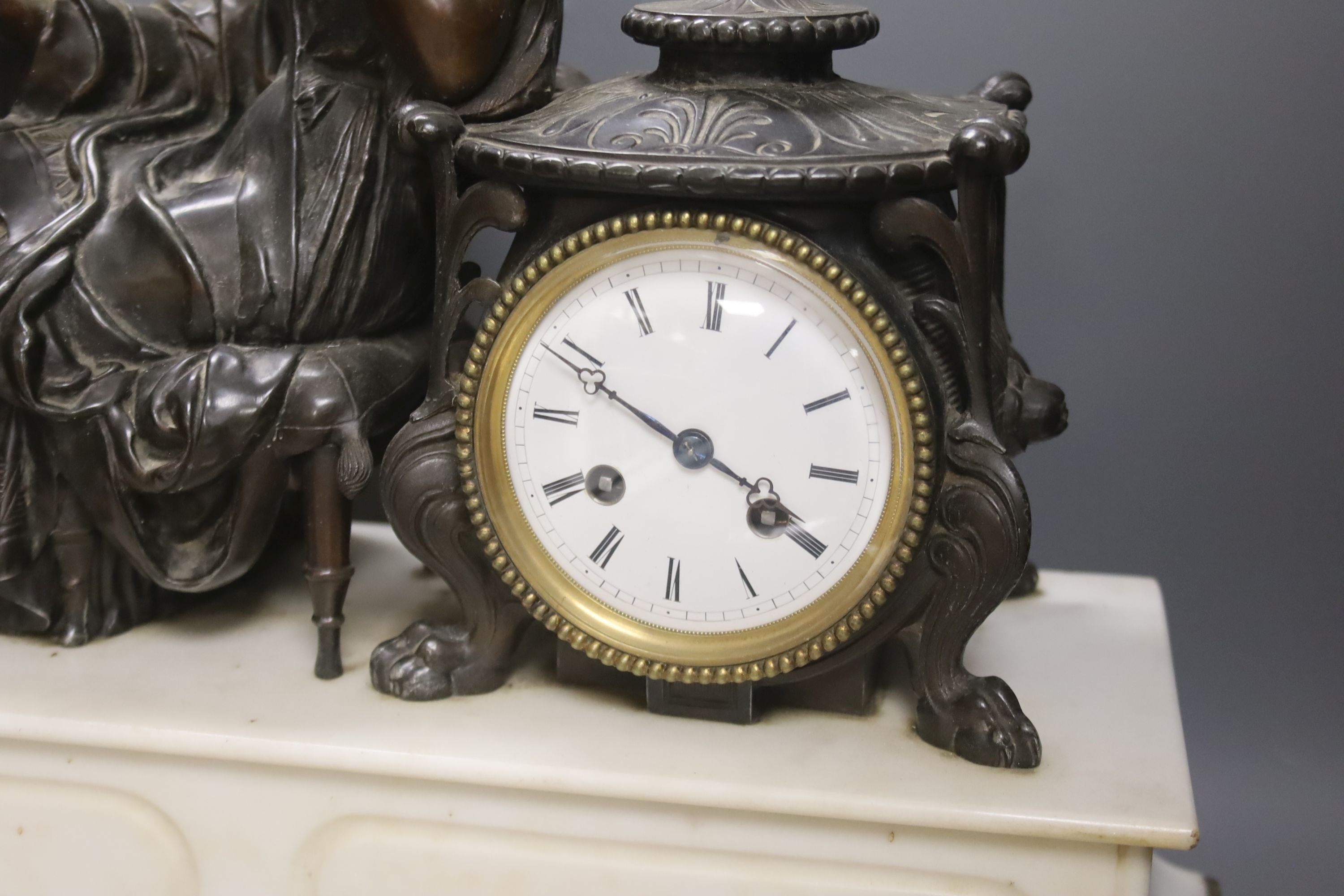A French marble and bronzed metal figural mantel clock. 49cm